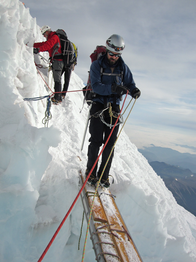 Doug makes his way across a ladder that bridges a gaping crevasse.
