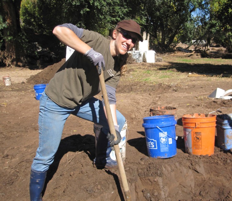 Moving countless buckets of mud as a flood relief volunteer.